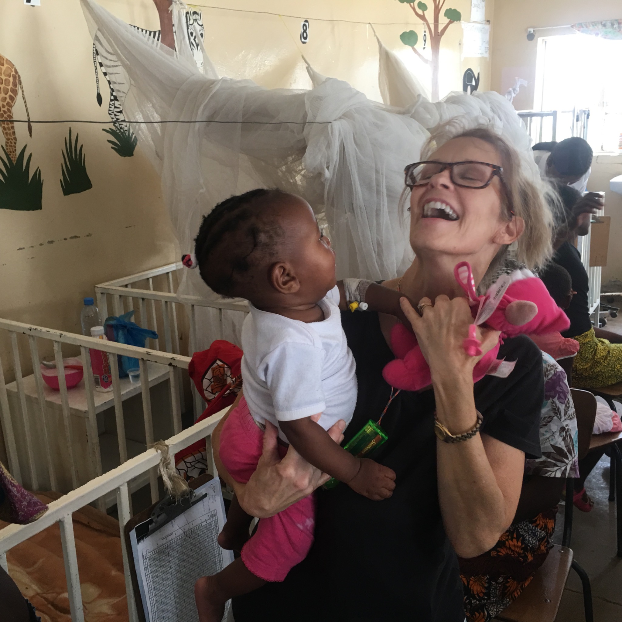 Karen sharing a joyful moment while holding a young child