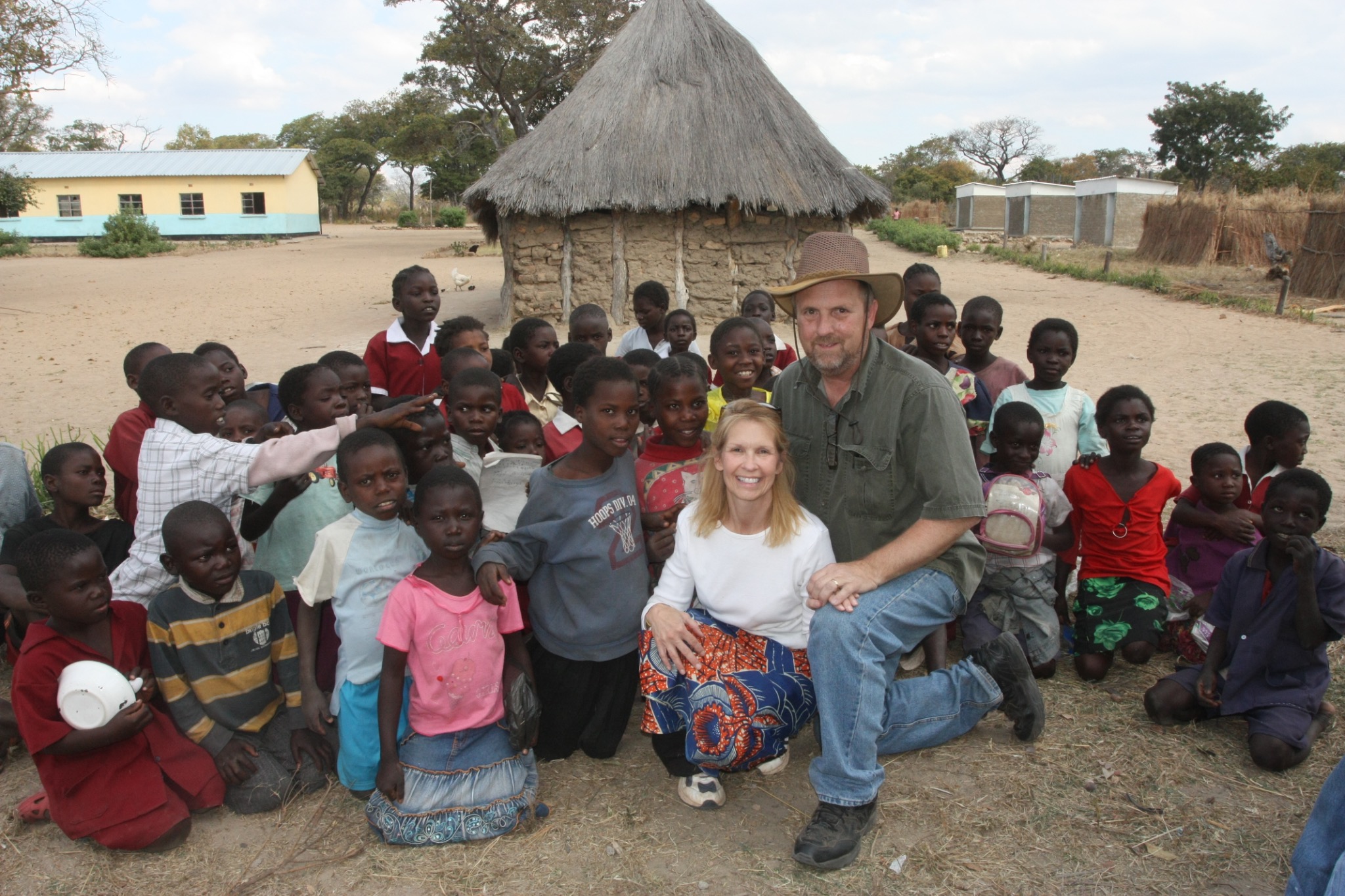 Ken and Karen Buckner with children in Zambia during the earliest days of CGWU